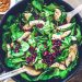 Healthy and vibrant spinach salad with grilled chicken and pomegranate seeds, perfect for a nutritious meal.